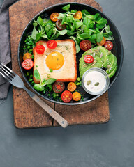 Fried egg on bread with vegetables