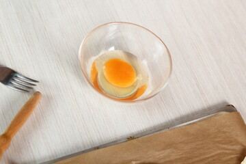 Cracked Egg in Bowl. Making Salmon in Puff Pastry Series.
