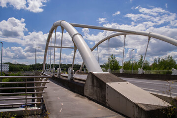Obraz premium view of the road and bridge with iron railings