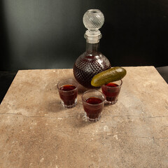 decanter with red wine and cucumbers