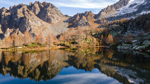 Colorful autumn view of small mountain lake with water reflection. Morning light. Alps, Italy, Europe. © Andrea
