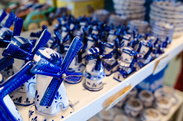 Kinderdijk, The Netherlands, August 2019. Miniature of a ceramic windmill, an icon of these places. Characteristic is the blue and white color.