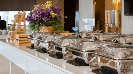 heating trays on buffet line ready for service. breakfast and lunch buffet food catering banquet in...