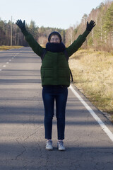Fototapeta premium the tourist girl put her hands up on the road