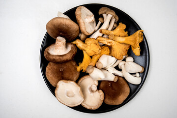 mushrooms of different types on a black plate