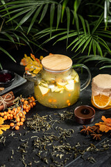 Fruit hot tea with the addition of oranges, lemons, mandarins and raspberries in a glass cups on a table. Healthy hot drink. tea with fruit and berries in a glass teapot. tea for colds.