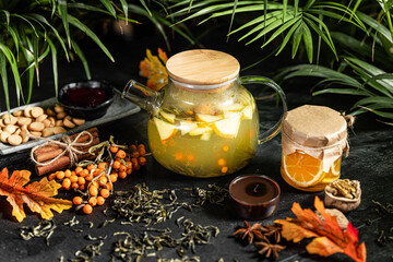Fruit hot tea with the addition of oranges, lemons, mandarins and raspberries in a glass cups on a table. Healthy hot drink. tea with fruit and berries in a glass teapot. tea for colds.