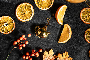 Fruit hot tea with the addition of oranges, lemons, mandarins and raspberries in a glass cups on a table. Healthy hot drink. tea with fruit and berries in a glass teapot. tea for colds.