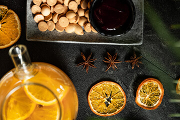 Fruit hot tea with the addition of oranges, lemons, mandarins and raspberries in a glass cups on a table. Healthy hot drink. tea with fruit and berries in a glass teapot. tea for colds.