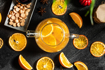 Fruit hot tea with the addition of oranges, lemons, mandarins and raspberries in a glass cups on a table. Healthy hot drink. tea with fruit and berries in a glass teapot. tea for colds.