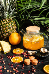 Fruit hot tea with the addition of oranges, lemons, mandarins and raspberries in a glass cups on a table. Healthy hot drink. tea with fruit and berries in a glass teapot. tea for colds.
