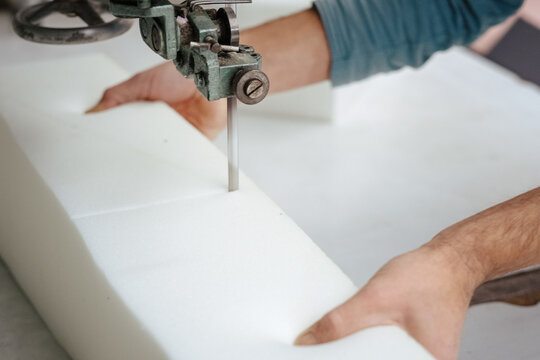 Closeup of a foam cutter machine, cutting through an upholstery foam