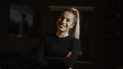 Obraz na płótnie Canvas Young blonde woman in black suit in office, confident business woman looking at camera portrait, young entrepreneur woman