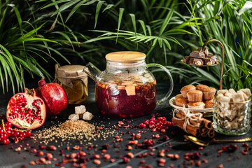 Fruit hot tea with the addition of oranges, lemons, mandarins and raspberries in a glass cups on a table. Healthy hot drink. tea with fruit and berries in a glass teapot. tea for colds.