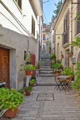 A narrow street among the old houses of Pietrelcina, a medieval village in the Campania region, Italy.
