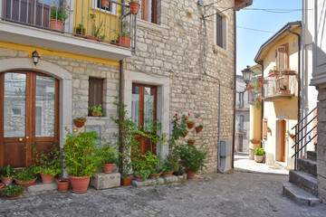 Fototapeta na wymiar A narrow street among the old houses of Pietrelcina, a medieval village in the Campania region, Italy.