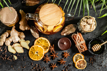 Fruit hot tea with the addition of oranges, lemons, mandarins and raspberries in a glass cups on a table. Healthy hot drink. tea with fruit and berries in a glass teapot. tea for colds.