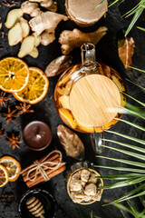 Fruit hot tea with the addition of oranges, lemons, mandarins and raspberries in a glass cups on a table. Healthy hot drink. tea with fruit and berries in a glass teapot. tea for colds.