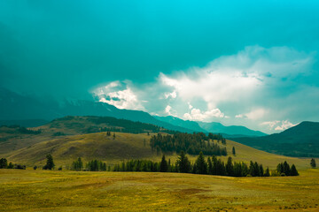 Majestic mountain landscape under the sky with clouds. Cloudy sky before the storm