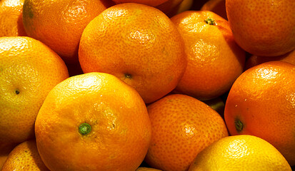 A bunch of fresh mandarins, as background