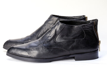 Close-up of women's black leather chelsea boots on a white background. Women's shoes for the city, urban lifestyle or travel. Fashion, design and shoes concept