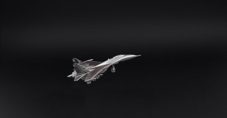 Fototapeta na wymiar silver plane fighter isolated on black background