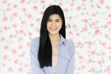 Cute and beautiful young black long hair Asian woman standing and smiling look at the camera with a self-confident and friendly pose