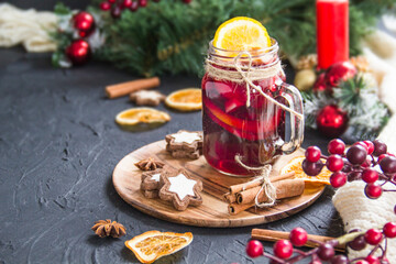 Christmas hot mulled wine with cinnamon cardamom and anise. Dark vintage dirty background. Creative...