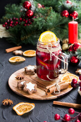 Christmas hot mulled wine with cinnamon cardamom and anise. Dark vintage dirty background. Creative...