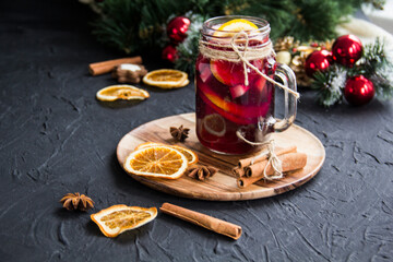 Christmas hot mulled wine with cinnamon cardamom and anise. Dark vintage dirty background. Creative...