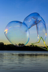 Soap bubble over water in the sky