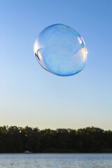 Soap bubble over water in the sky