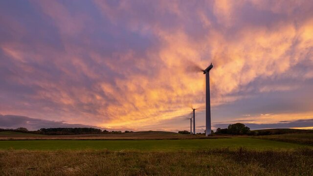 Time Lapse clip of three modern Windmills at sunset. Seen at a field near Kalundborg in Denmark