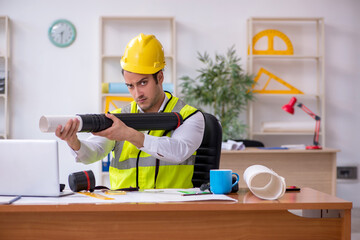 Young male architect working in the office