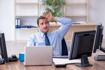 Young male employee unhappy with excessive work