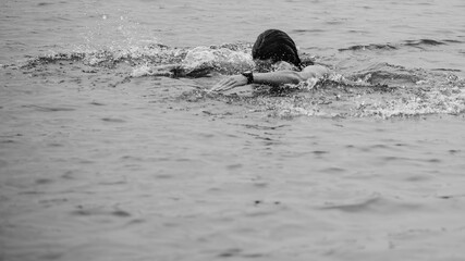 Black and White Portrait Swimming Athletic Young Man in Open Water