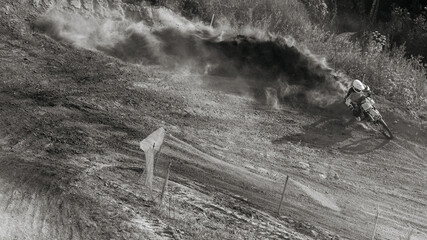 Rider and Huge Cloud of Dust on Motocross Competition. Dynamic Photo of Extreme Sports in Motion