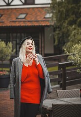 Fototapeta premium Woman at European cafe, plus size blonde nice woman . Pretty nice girl in restaurant at terrace with a cup of coffee, lifestyle ladies, tourist at Europe 