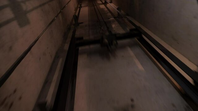 Passage in the Elevator shaft tunnel. Movement of the Elevator counterweight along the guides. Elevator shaft of a multi-storey building. Travel through the tunnel. Debugging of Elevator equipment. Pr