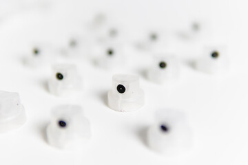 transparent caps on a white background close-up focus on one cap