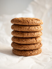 Fototapeta na wymiar Oatmeal cookies on white background in morning light close up