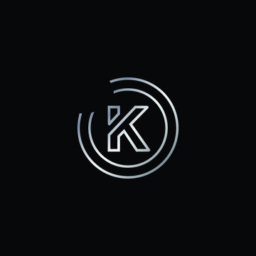 Elegant Design of K Alphabet . Silver Enclosure Logo Design For Letter K. Uppercase Letter K is Enclosed in Two Circle. Modern and Unique Logo Design For Letter K.
