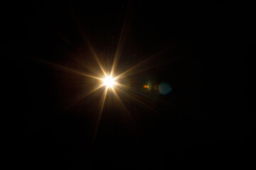 Easy to add lens flare effects for overlay designs or screen blending mode to make high-quality images. Abstract sun burst, digital flare, iridescent glare over black background.