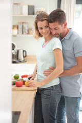 happy couple cooking together in their kitchen