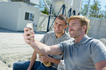 industrial male workers taking selfie during the break © auremar