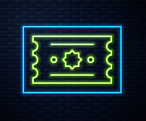 Glowing neon line Ticket icon isolated on brick wall background. Amusement park. Vector.