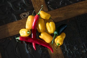 Yellow, red and green peppers on a rustic table