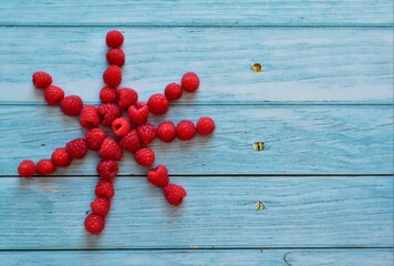 ripe raspberries on a wooden table