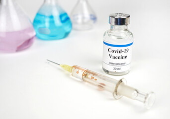 COVID-19 vaccination and syringe, vaccination and treatment from coronavirus infection, blurred...