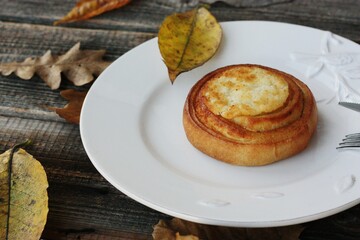 Delicious bun with cottage cheese on a wooden table 